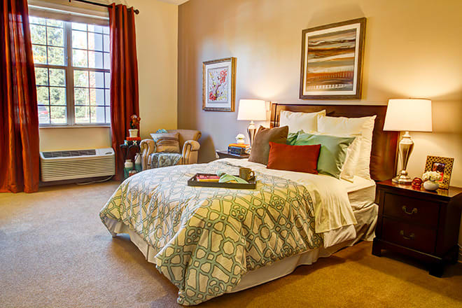 A cozy bedroom with warm lighting and elegant decor.