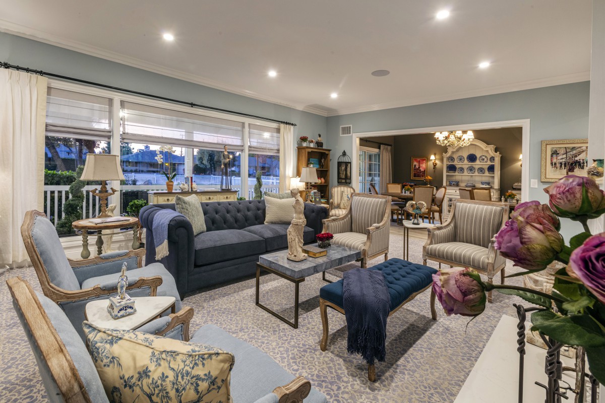 A stylishly designed living room with comfortable seating, elegant decor, and warm lighting.