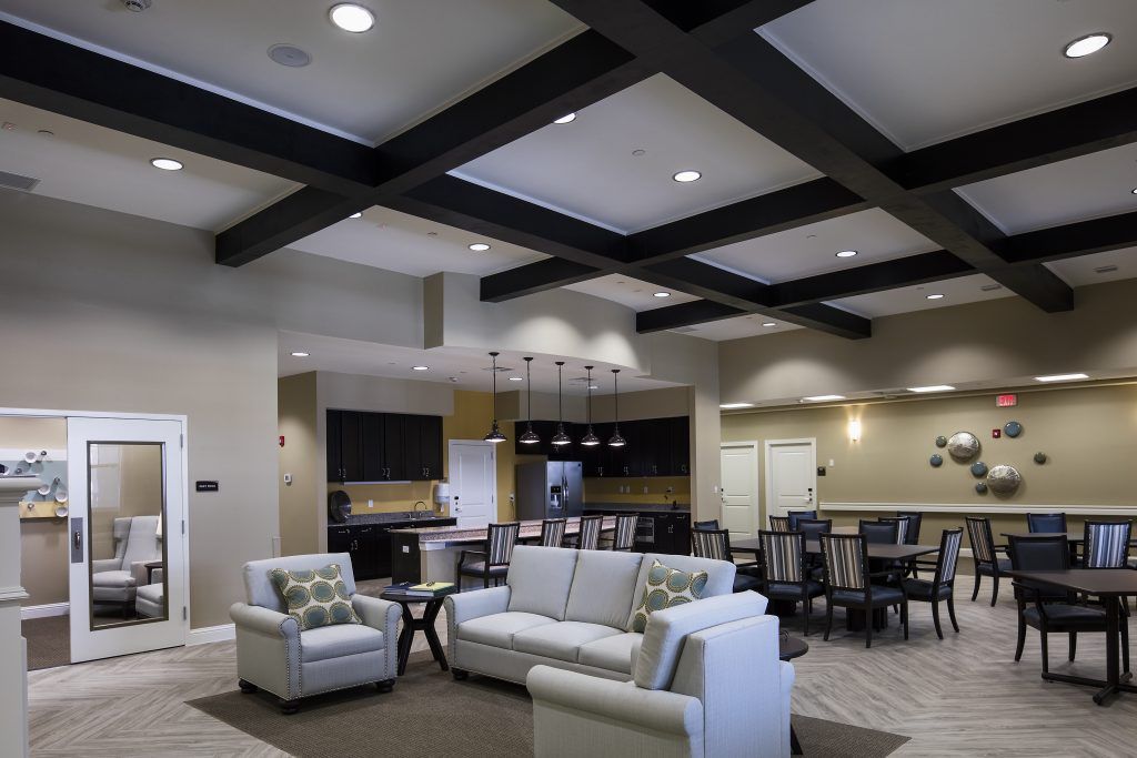 A modern open-concept living room with comfortable sofas and elegant lighting.