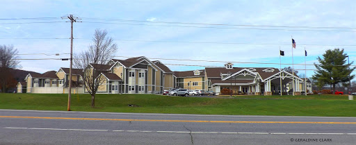 A view of a hotel complex featuring multiple buildings and well-maintained lawns.