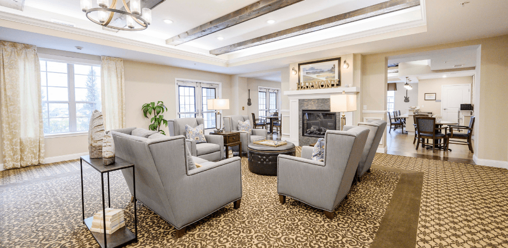 A cozy and modern living room with comfortable seating around a fireplace.