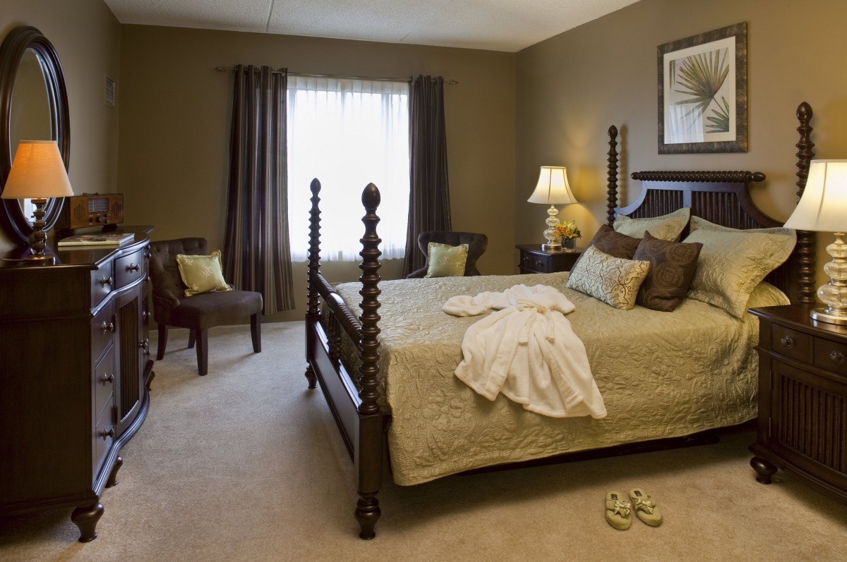 A cozy bedroom with elegant decor and a comfortable bed.