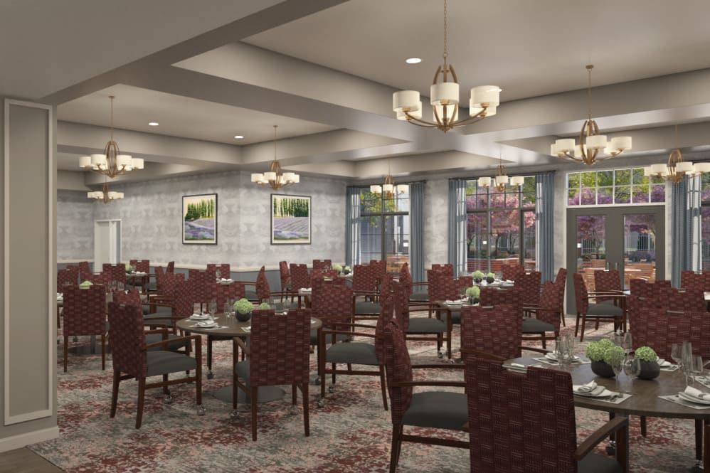 A spacious and elegantly designed dining area with neatly arranged tables and chairs, complemented by soft lighting.