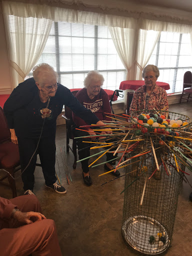 Residents of a care facility enjoying a game together.