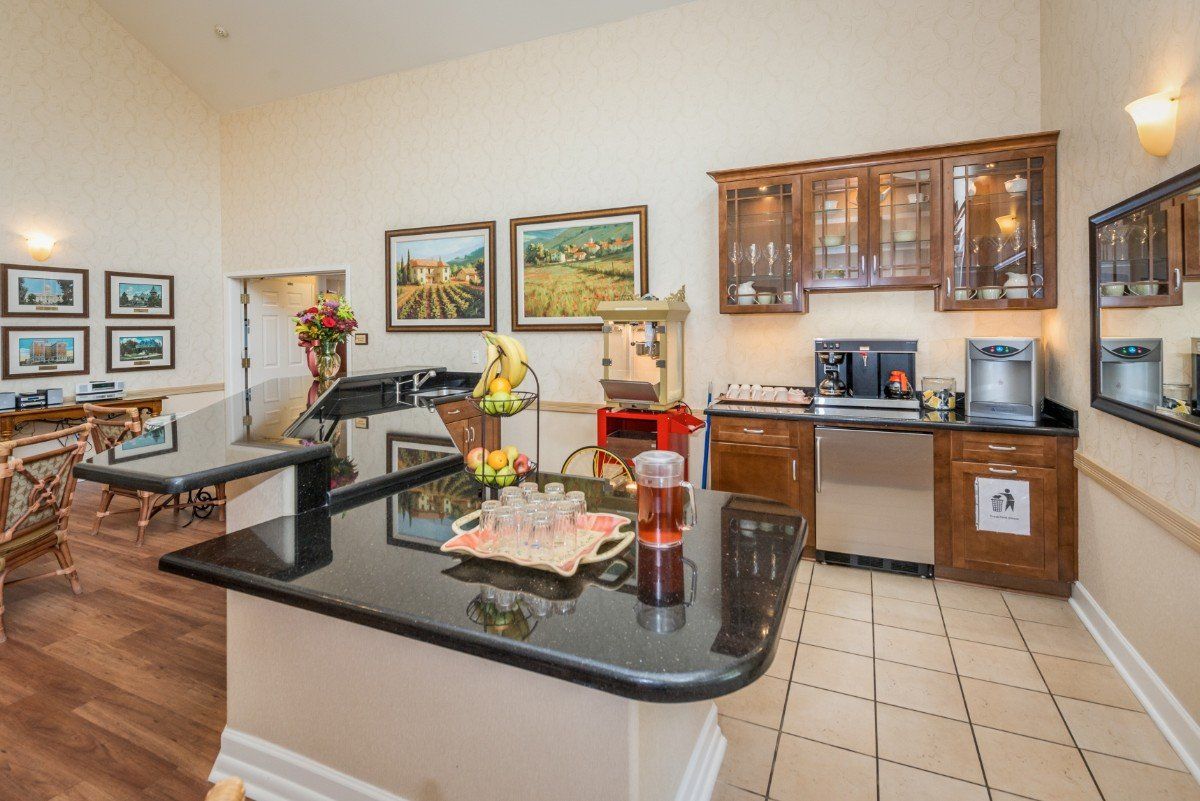 Bright modern kitchen with a black countertop and wooden cabinets.