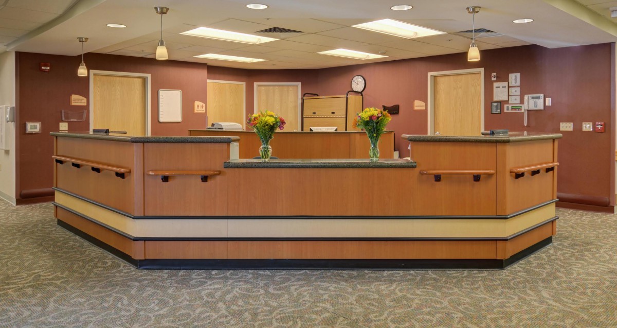A welcoming office reception desk adorned with floral arrangements.