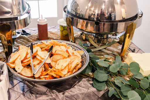 A savory spread featuring crispy potato wedges on a buffet table.