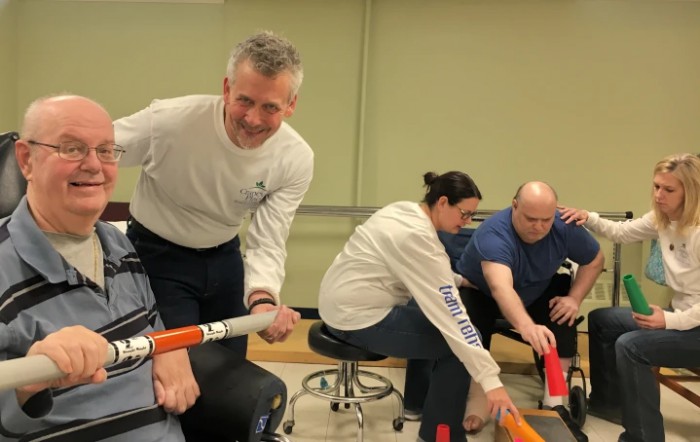 A group of people engaging in a team-building activity indoors.