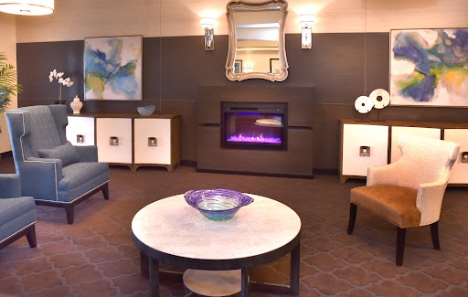 A cozy and modern living room featuring a stylish fireplace and elegant furniture.