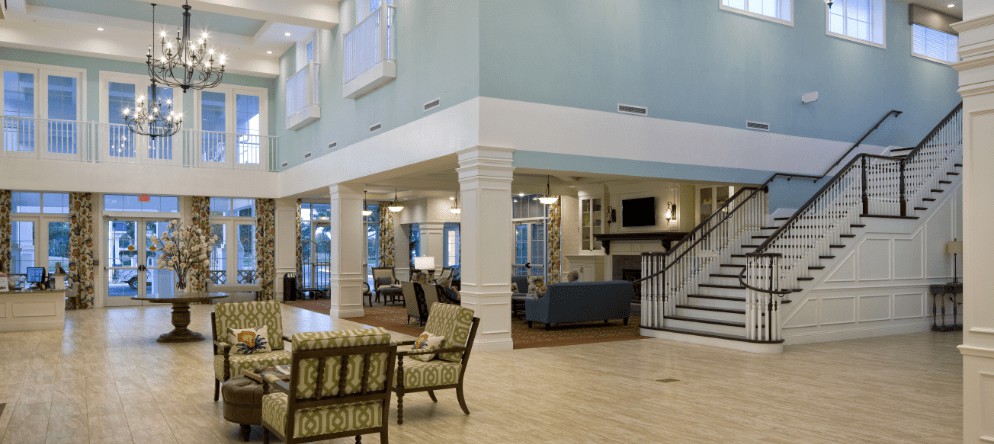 A spacious living area with elegant furniture and a staircase.