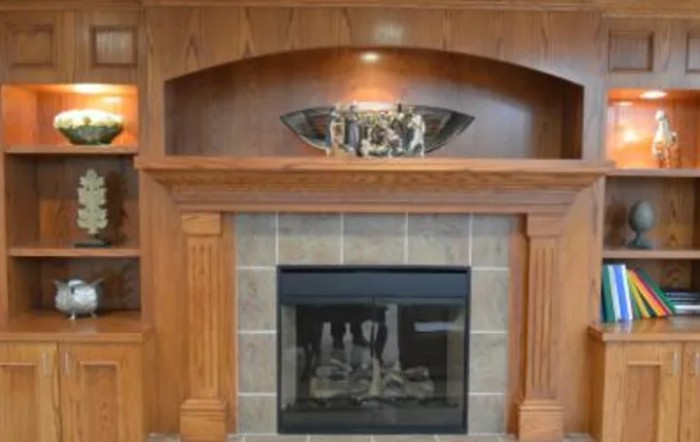 A stylish wooden fireplace with a decorative mantel.