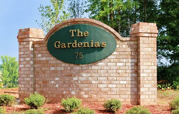 Entrance sign for 'The Gardenias' community.