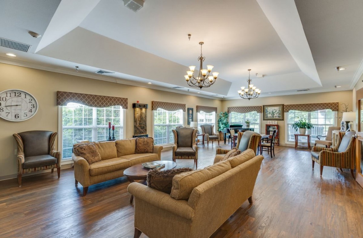 Spacious and elegantly decorated living room with comfortable seating and large windows.