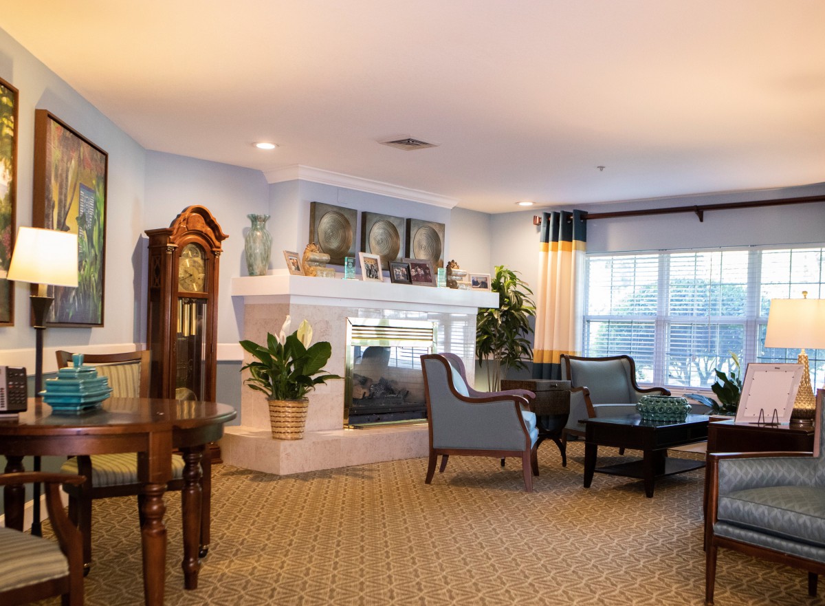 A cozy living room with a fireplace, comfortable seating, and tasteful decor.