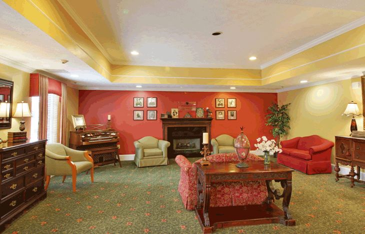 A cozy living room with a fireplace and traditional decor.