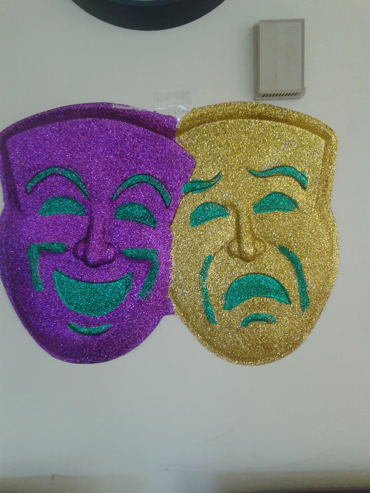 A pair of comedy and tragedy theater masks, representing the dramatic arts.