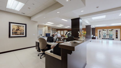 A modern office reception area with workspace and comfortable seating.