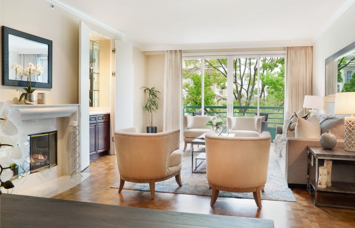 A bright and cozy living room with comfortable seating and large windows letting in natural light.