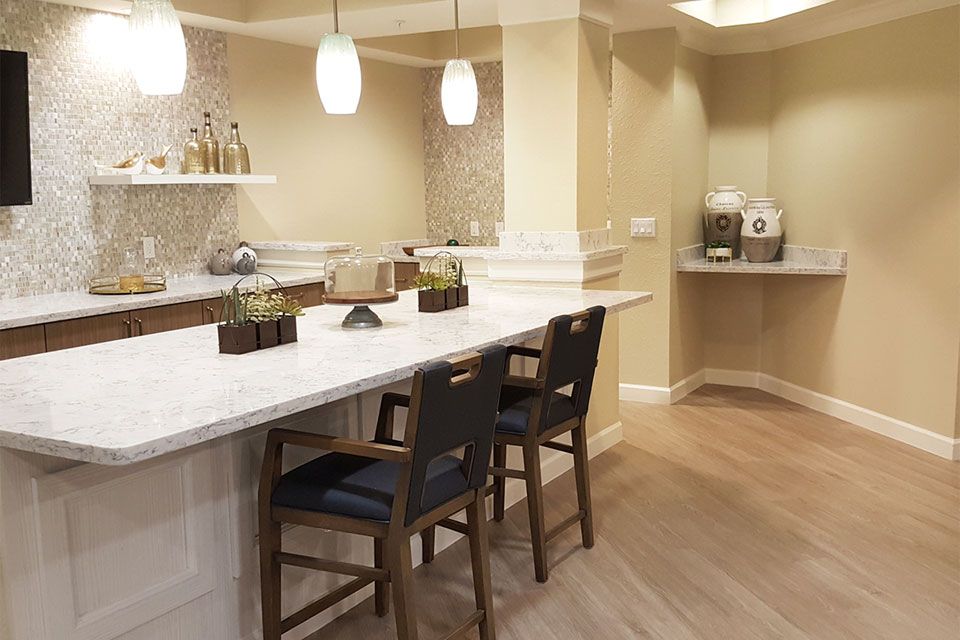 Modern kitchen interior with a stylish countertop and bar seating.