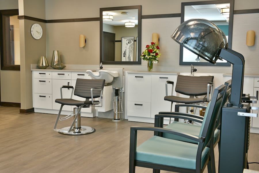 A well-organized hair salon with styling chairs and mirrors.