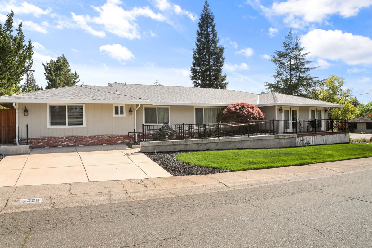 A suburban house with a well-maintained front yard and driveway.