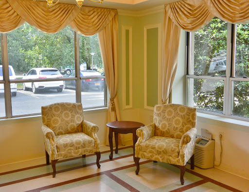 Cozy seating area with patterned chairs and natural light.