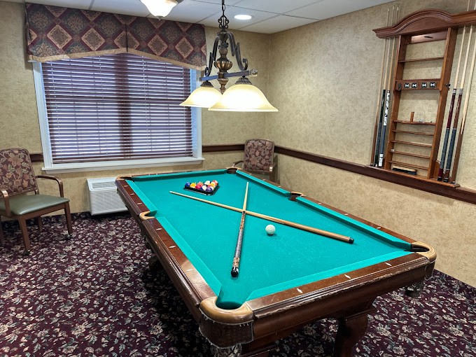 A cozy game room featuring a pool table set for play.