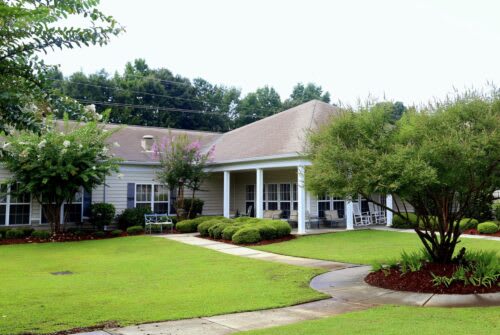 A suburban house with a well-maintained lawn and garden.