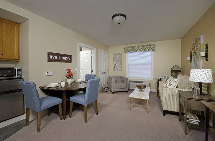 A cozy living room with a small dining area featuring comfortable seating and tasteful decor.
