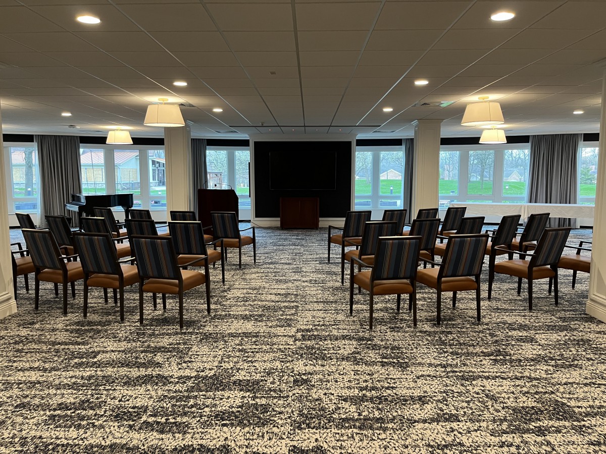 A neatly arranged conference room with chairs set up for a meeting.