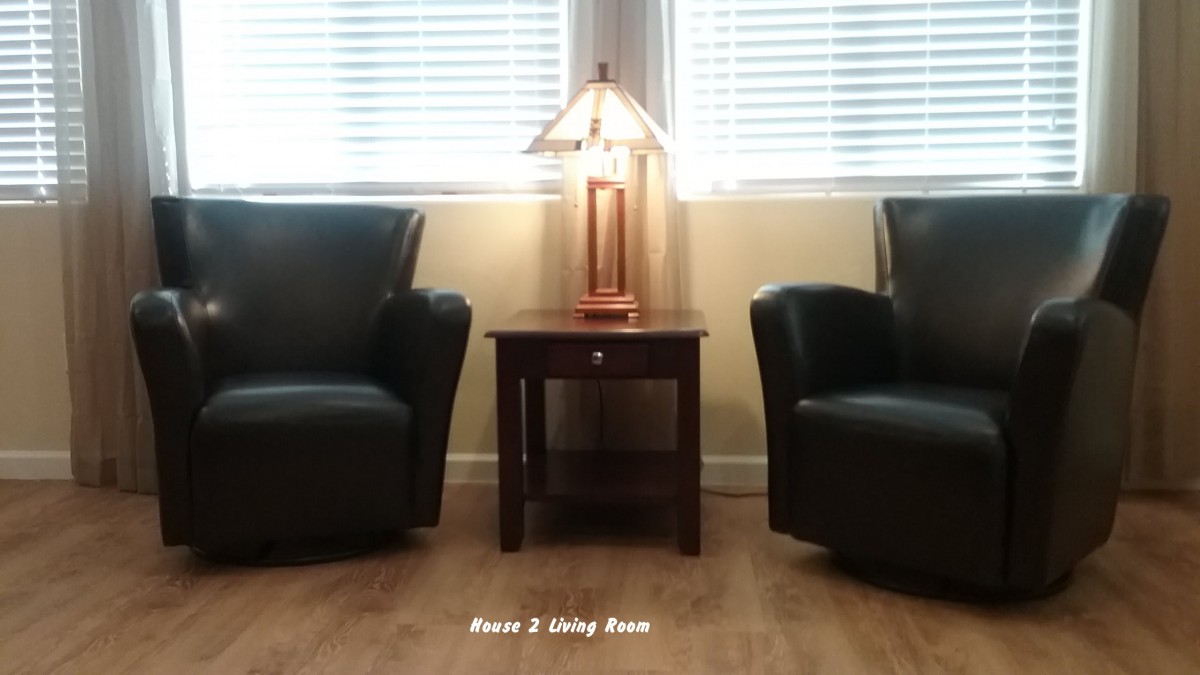 A cozy living room setup with two chairs, a lamp, and a side table.