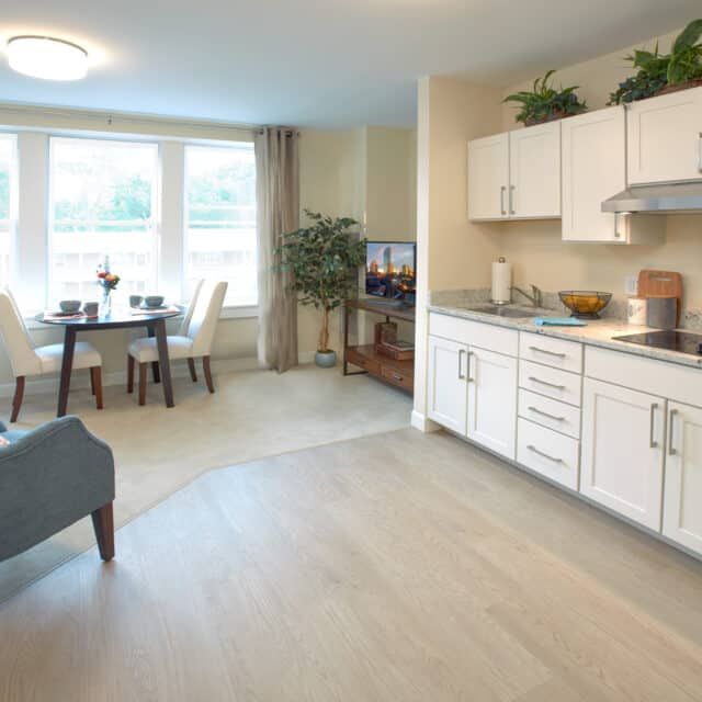 A bright and modern open-concept living area with a kitchen and dining space.