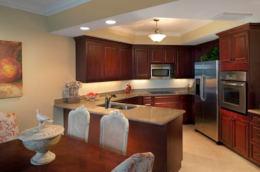 A beautifully designed modern kitchen featuring wooden cabinets, stainless steel appliances, and an inviting dining area.