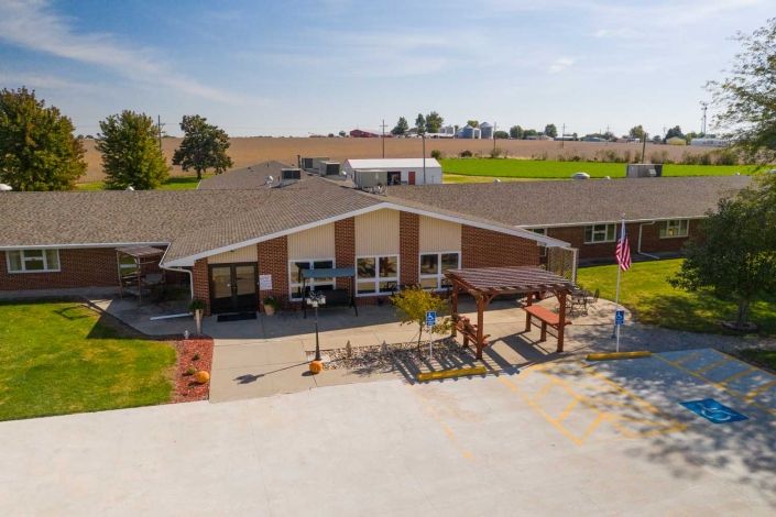 A rural facility with a large outdoor area on a sunny day.