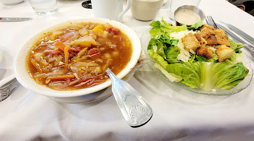 A delightful meal featuring a hearty vegetable soup alongside a fresh garden salad.