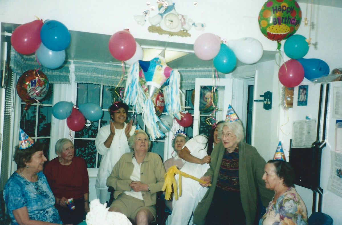 A joyous indoor celebration with balloons and party hats.