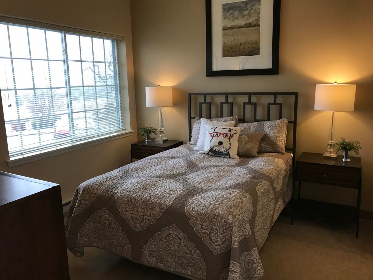 Cozy bedroom with elegant decor and warm lighting.