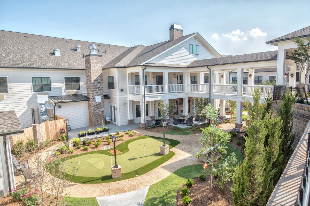 A spacious residential building with a landscaped yard and modern architecture.