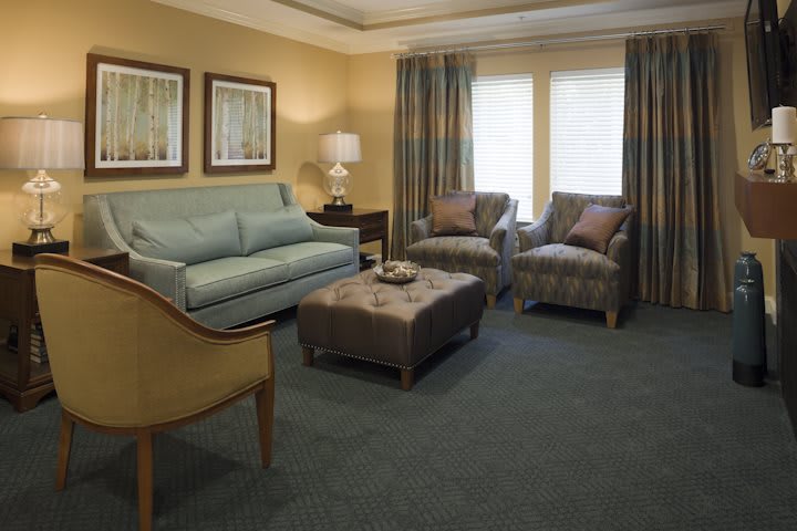 A cozy living room with a sofa, armchairs, and a coffee table.