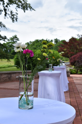 An elegant outdoor setup featuring tables adorned with floral arrangements, perfect for a special event.