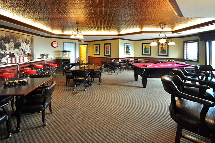 A spacious billiard room with pool tables and comfortable seating for leisure and games.