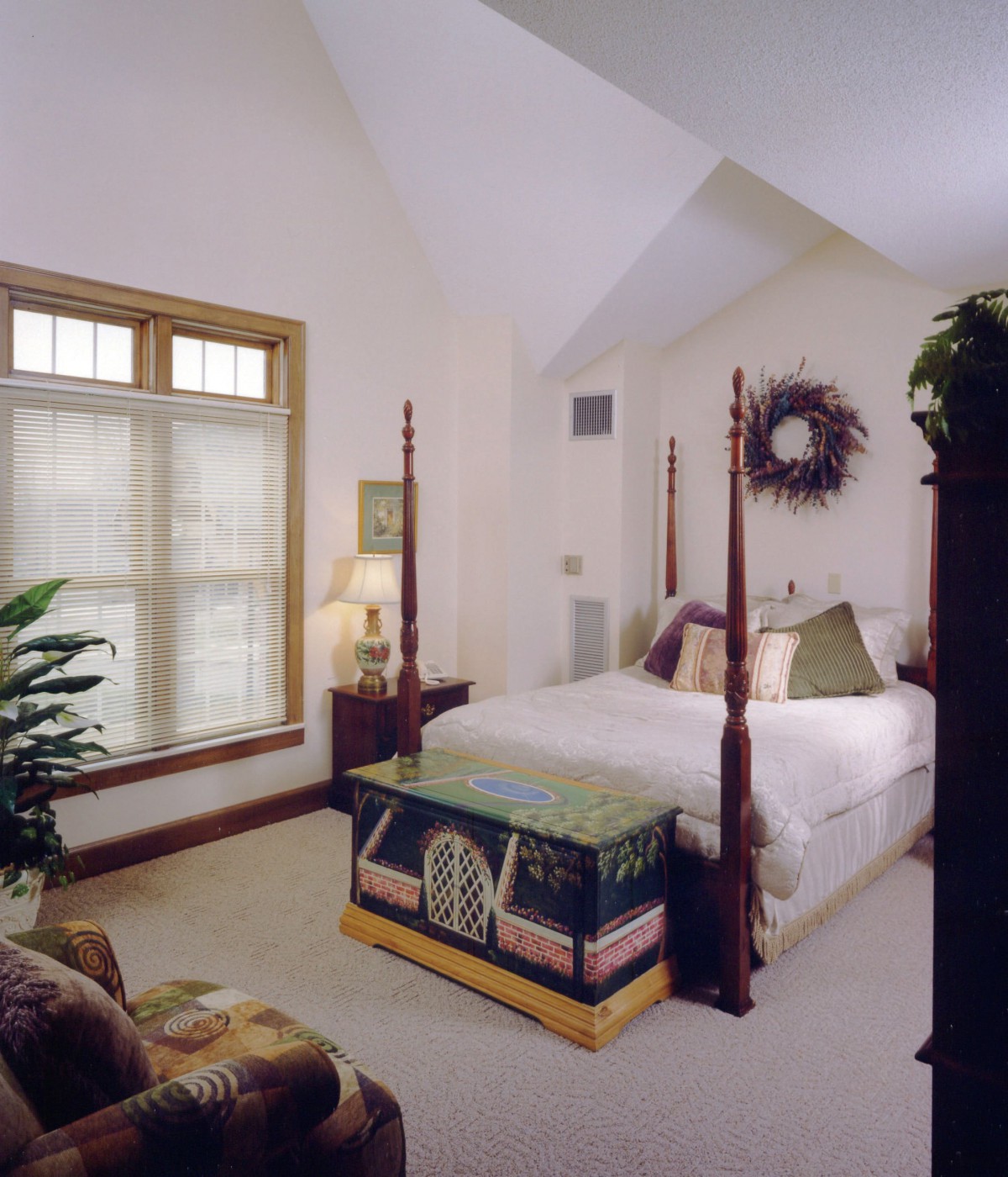 A cozy bedroom with a four-poster bed and elegant decor.