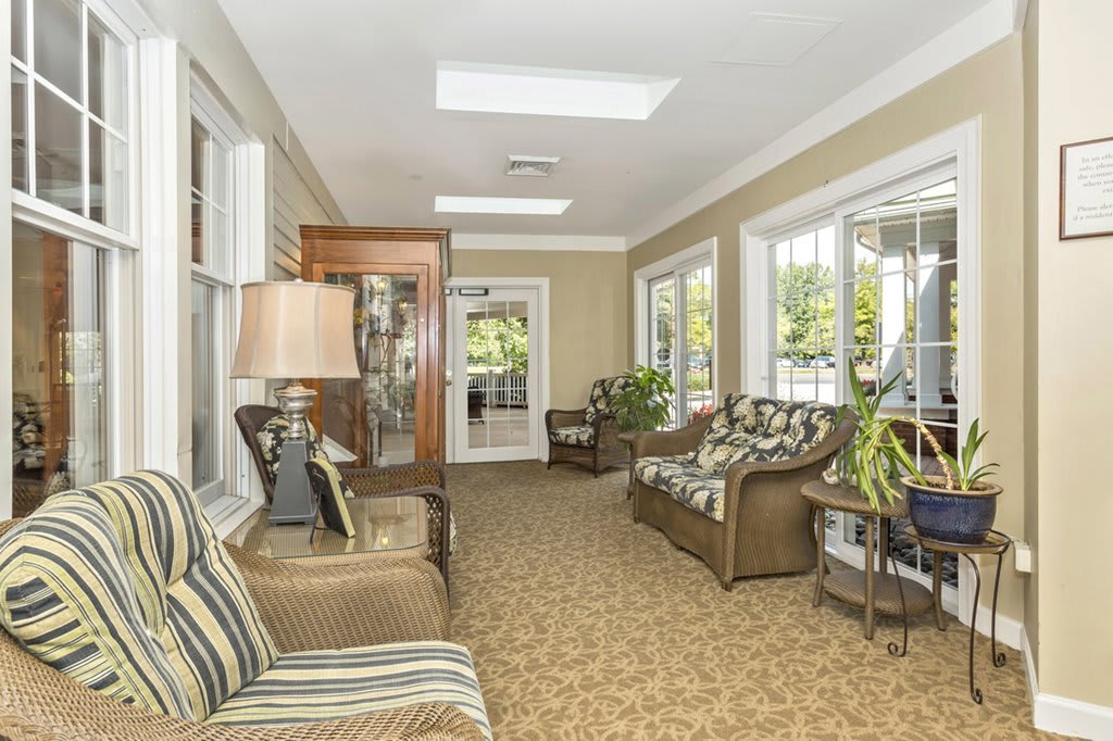 A cozy living room with ample natural light and comfortable seating.
