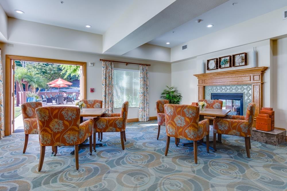 A cozy dining area with patterned chairs and abundant natural light.