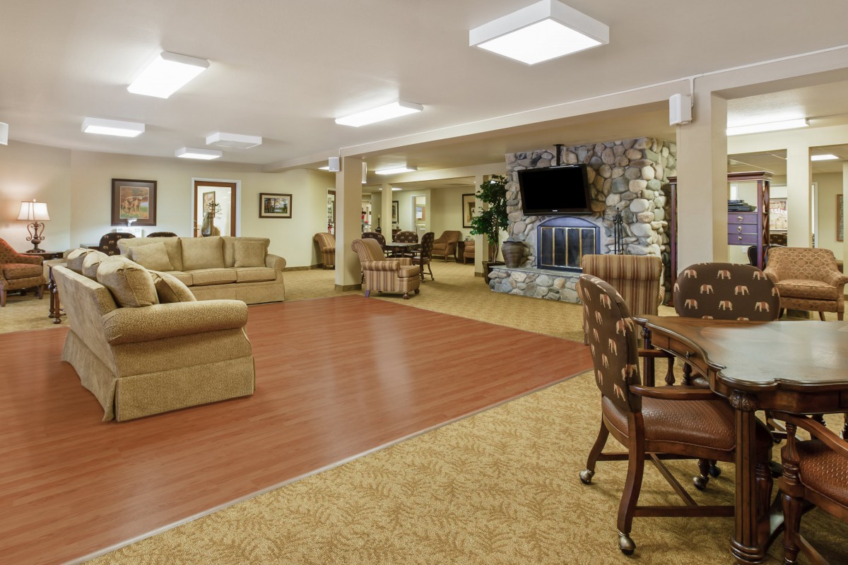 A spacious living room with comfortable seating and a large television.
