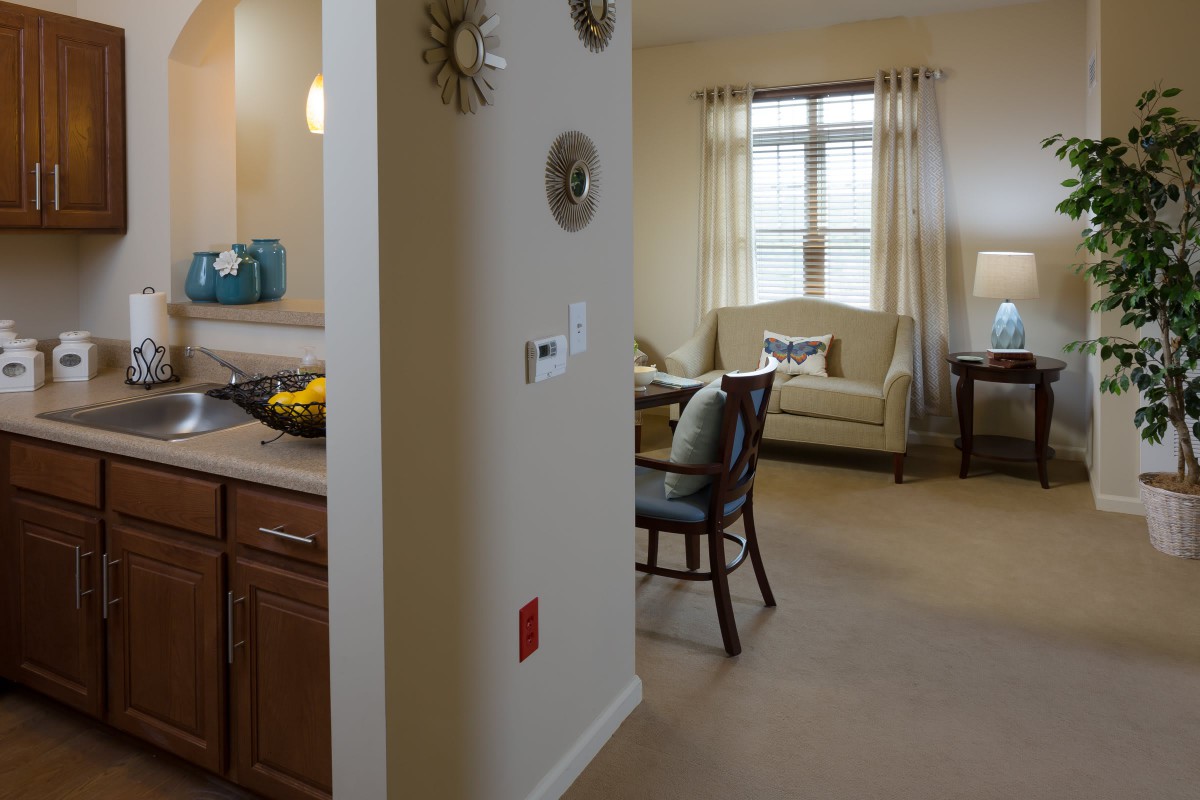 A modern apartment interior featuring an open kitchen and cozy living room with stylish decor.