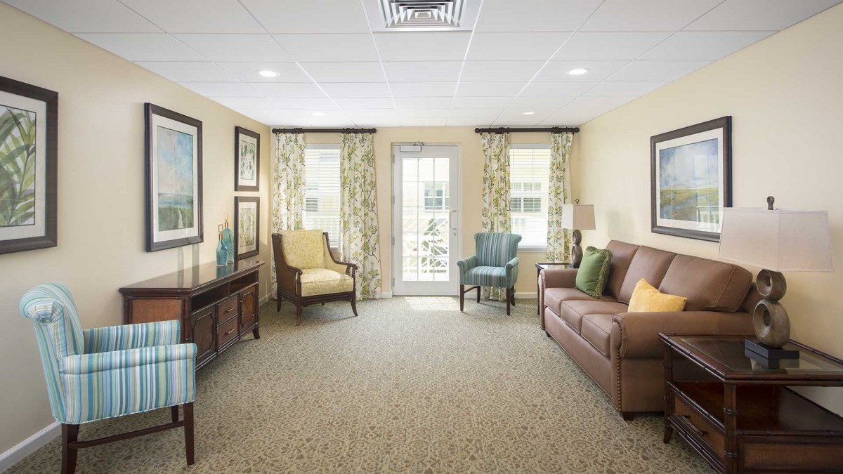 A cozy and well-lit living room with comfortable seating and elegant decor.