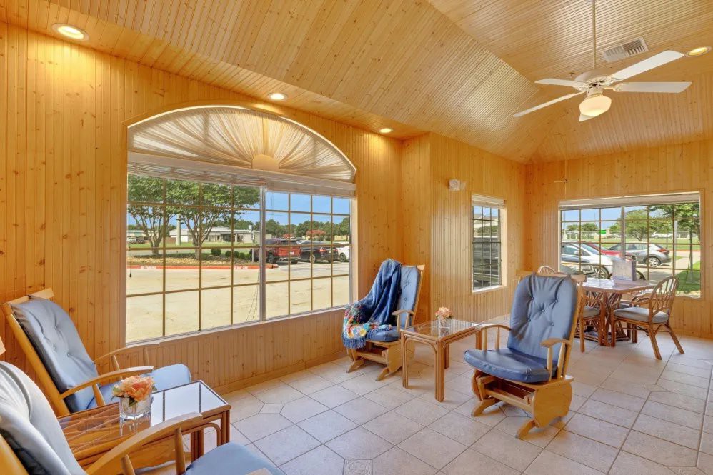 A bright waiting room with comfortable chairs and large windows.