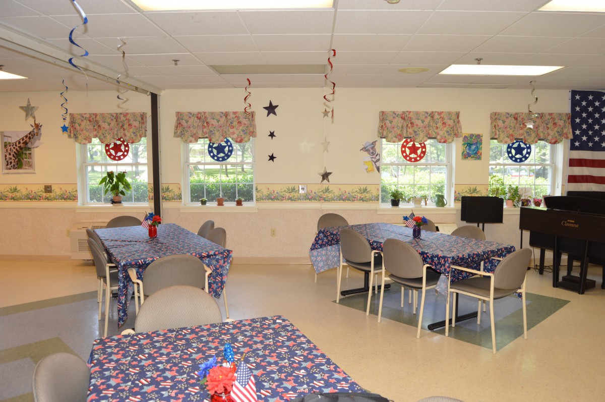 A community dining area decorated with a patriotic theme, featuring tables and chairs.