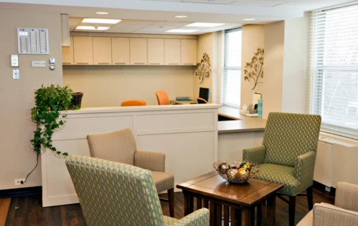 A cozy waiting room with comfortable seating and a reception desk.